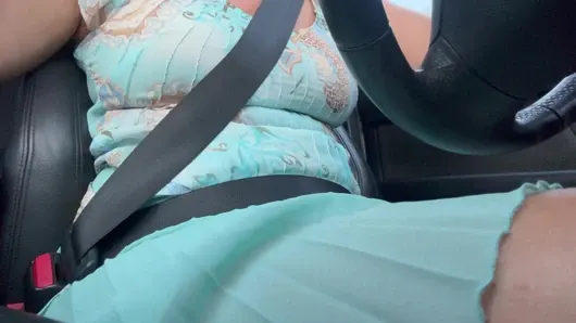 An elegant lady drives to work and rubs her pussy with her hand between her hot thighs